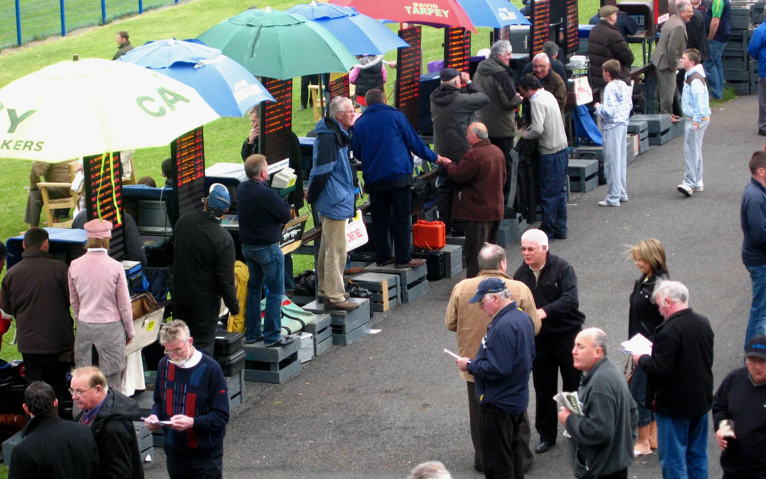 Bookmaker boards showing live betting prices at a UK racecourse